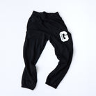 Black Prof G Collegiate jogger sweatpants featuring minimalist white collegiate logo graphic.